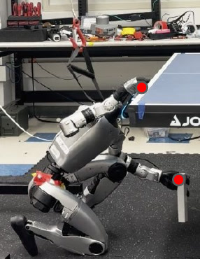 The real humanoid robot kneels at the table, touching the same contact points.